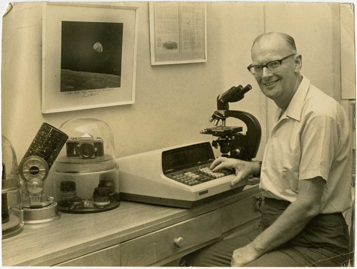 Arthur C. Clarke at his desk with his Questar telescope